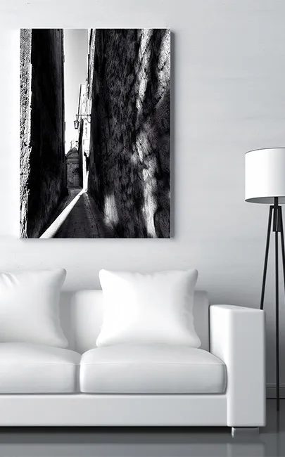 Black and White canvas an Mdina Alley fixed above a White sofa in the living room