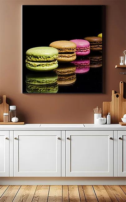 Canvas of coloured macaroons with a black background fixed on a kitchen wall