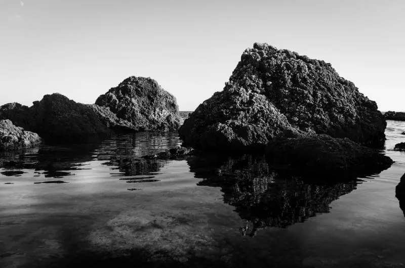 black and white photo of the maltese coastline from Ghar Lapsi with rock reflections on seawater