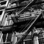 metal stairs outside housing buildings in New York in black and white