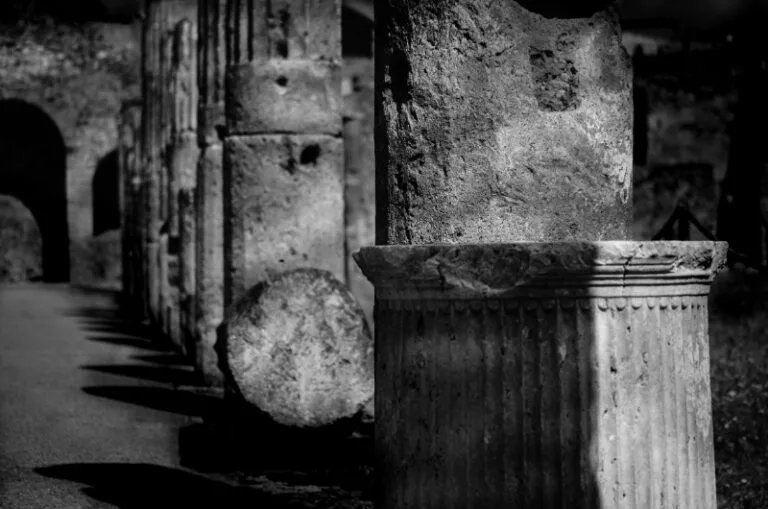 Roman remains including an arch and columns at Pompeii in monochrome