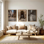 A cozy living room featuring a couch, coffee table, and two framed pictures of Mdina's timeless streets.