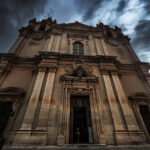 Mdina Cathedral, a grand structure with a clock on the front, exemplifying historical architecture and cultural significance.