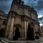 A majestic Mdina cathedral with a central clock tower, highlighting its impressive structure and historical significance.