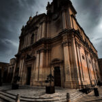 The mdina cathedral with a central clock tower, highlighting its impressive structure and historical significance.