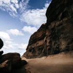 A rugged, rocky canyon under a blue sky with scattered clouds at Gozo Qbajjar