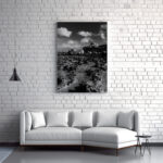 A white couch positioned in front of a striking black and white photograph, enhancing the room's aesthetic appeal.