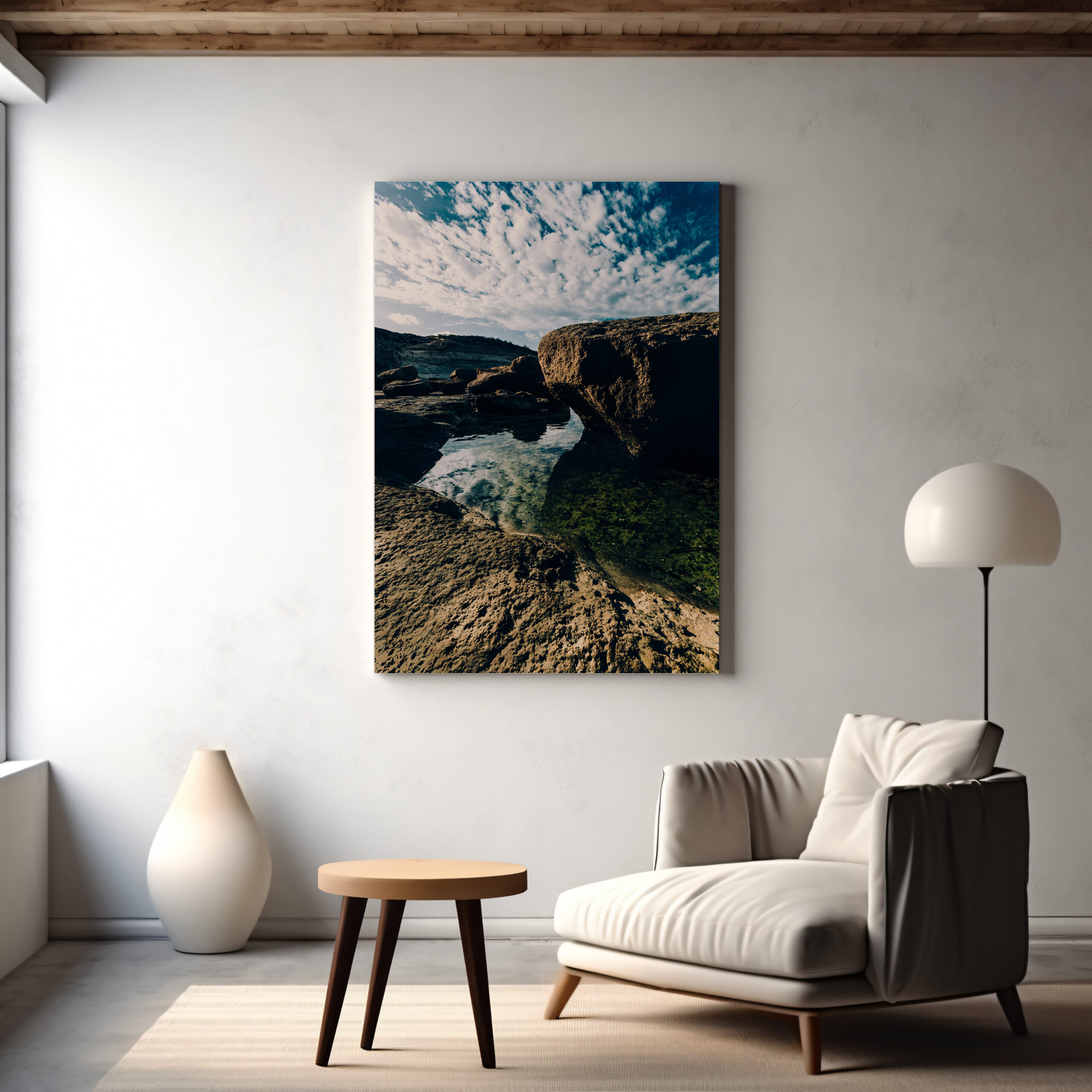 In a living room, a large canvas print of the Gozo Qbajjar Coastline adorns the wall above a chair, contributing to the room's inviting atmosphere