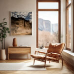 An inviting living room with a modern chair and a framed print of the Gozo Qbajjar canyon, contributing to a warm and artistic environment