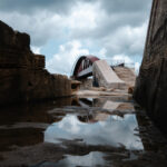 A Valletta's old bridge mirrored in tranquil waters, showcasing a stunning sky reflection.