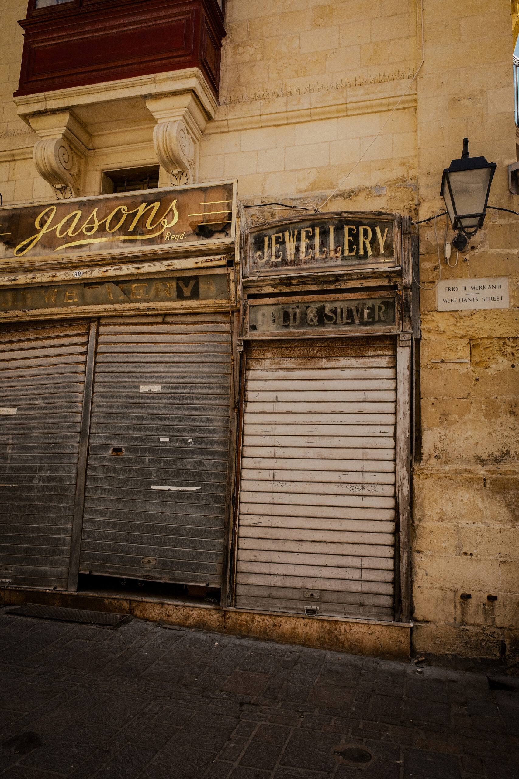 Shuttered doors of an old jewellery shop in Valletta, highlighting the building's unique architectural style.