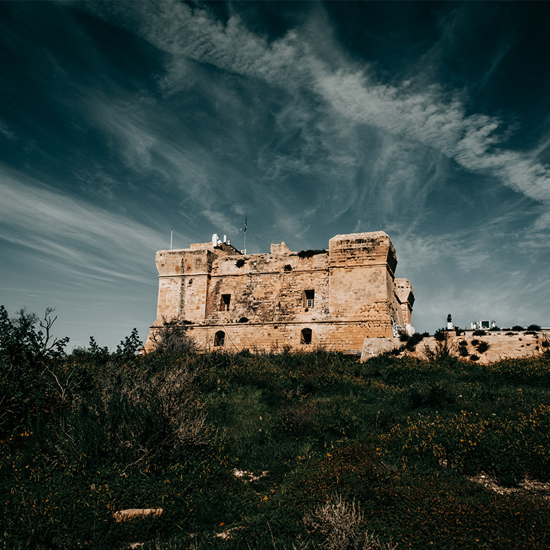 Historic Fort San Lucian under a dramatic sky in Marsaxlokk, Malta
