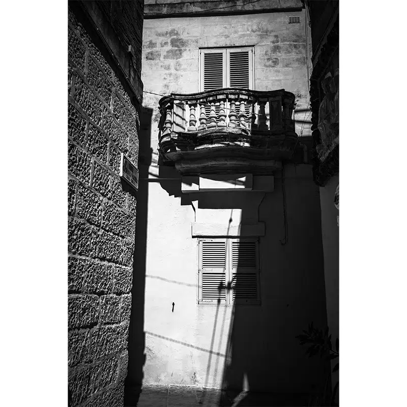 raditional Maltese stone balcony in dramatic shadows, Rabat.