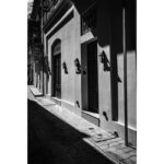 Shadows cast across a stone street and doorway in Rabat, Malta.