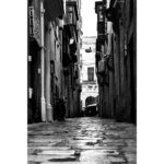 Black and white view down Strait Street, a narrow alley in Valletta, Malta.