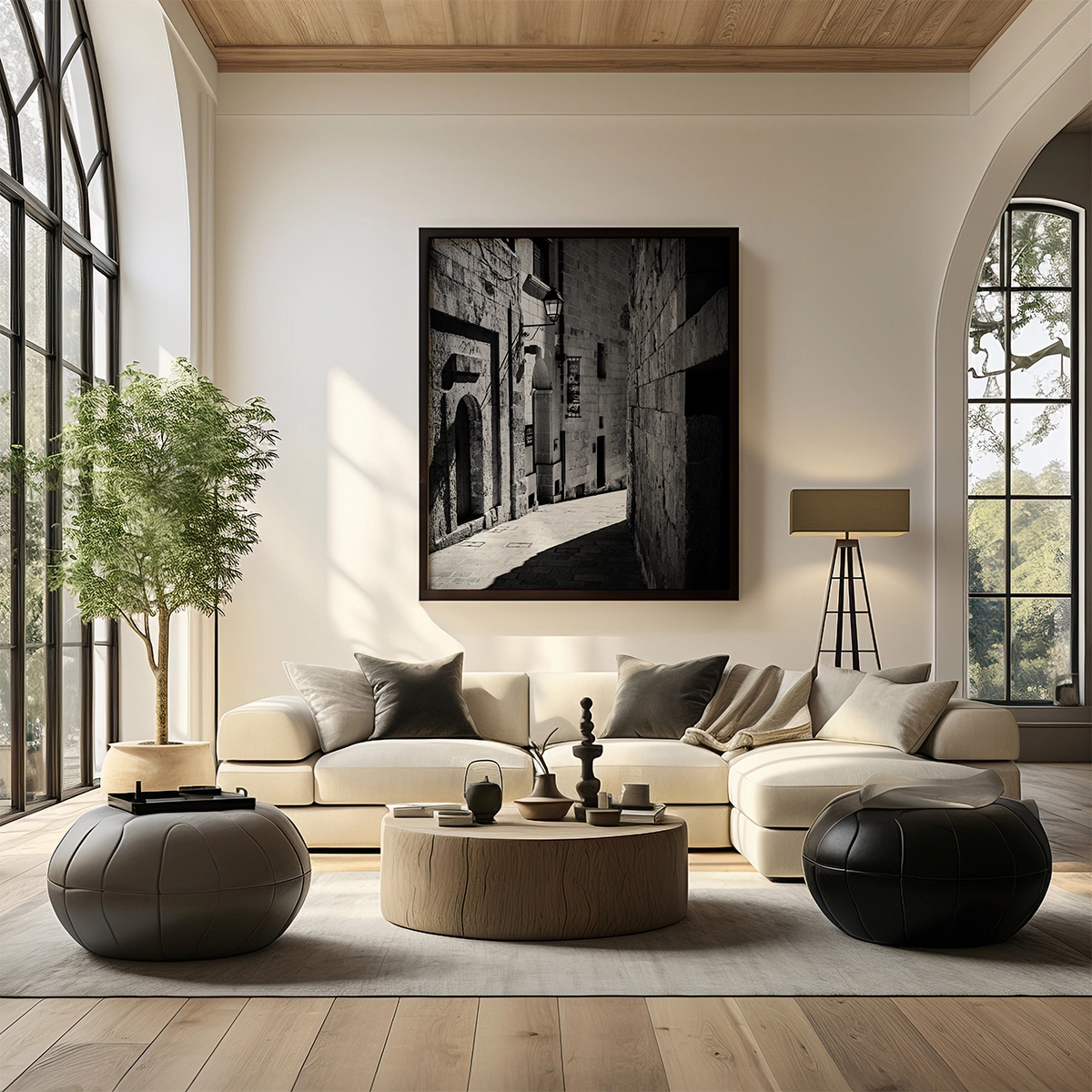 Large black and white alleyway photograph above modern beige sofa