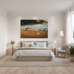 A person's hand gently sifts through a handful of smooth, colorful pebbles on the sandy shore of Ramla Bay in Gozo, with the clear blue Mediterranean Sea and a distant, verdant hillside in the background under a bright sky.