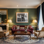 A person stands in front of the historic Citadel Gozo Clock Tower, holding up a beautifully designed mockup of the tower. The setting is a sunny, outdoor lifestyle shot, highlighting the architectural details of both the actual tower and its miniature representation.