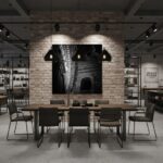 A large, framed print of the Mgarr Malta Church Arch hangs above a modern sofa in a brightly lit living room, with a decorative vase and books on a coffee table in the foreground.