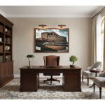 A living room with a framed print of Gozo Qbajjar Battery Arches on the wall above a sofa, with natural light coming in from a window.
