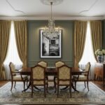 A serene living room with a large window overlooking a city, a stylish sofa with throw pillows, a coffee table with books and a mug, and a wall art print of the Malta Mdina Arch Balcony hanging above the sofa.