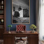 A stunning view of the Mediterranean Sea from a modern living room, with a large framed print of Malta Mtahleb Church on the wall above a minimalist sofa.