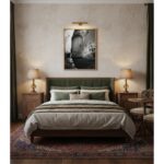 A framed print of the Mgarr Malta Townhouse Steps is displayed on a living room wall above a beige sofa with throw pillows, a white coffee table, and a potted plant, creating a serene and inviting atmosphere.