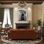A framed print of the Rabat Malta Augustinian Friars Facade hanging on a light grey wall above a brown leather sofa with a white cushion and a soft grey throw, in a bright, modern living room.