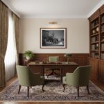 A coastal living room with a large window overlooking the sea. A digital print of Rabat Malta Zuntier St. Pauls Church View is hanging on the wall above a light grey sofa with throw pillows.