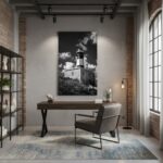 A person gazes at the Malta Marsaxlook Lighthouse at sunset, holding a print of the lighthouse, with the warm light reflecting on the water.