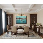 A person holding a mockup of the Malta Marsaxlokk harbour design in a lifestyle setting, with the harbour and boats visible in the background.