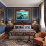 A traditional Maltese Luzzu fishing boat with the iconic eye of Osiris, adorned with colorful patterns and fishing gear, sails on the clear turquoise waters of Marsaxlokk Bay under a sunny sky.