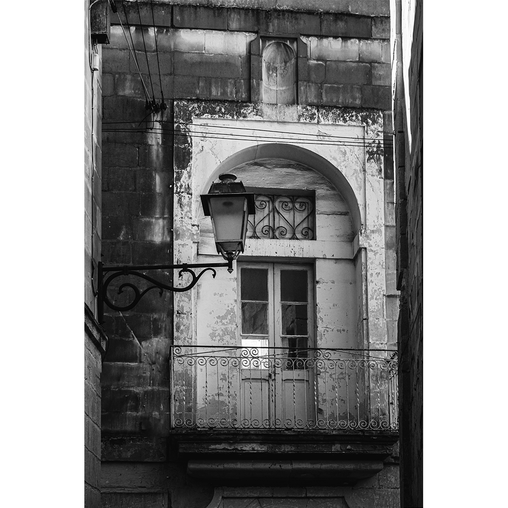 Old stone balcony with wrought iron railing