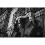 Ornate historic building facade with wrought-iron balcony