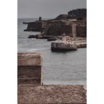 Historic coastal fort with lighthouse and breakwater