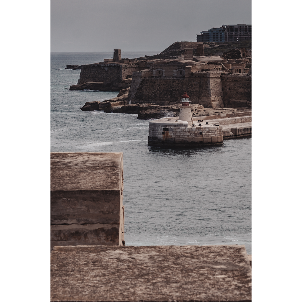 Historic coastal fort with lighthouse and breakwater