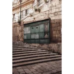 Stone steps leading to weathered green doors