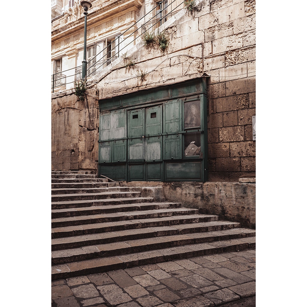 Stone steps leading to weathered green doors