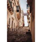 Narrow stone staircase between historic European buildings