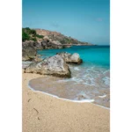 Rocky shoreline with turquoise water and sandy beach