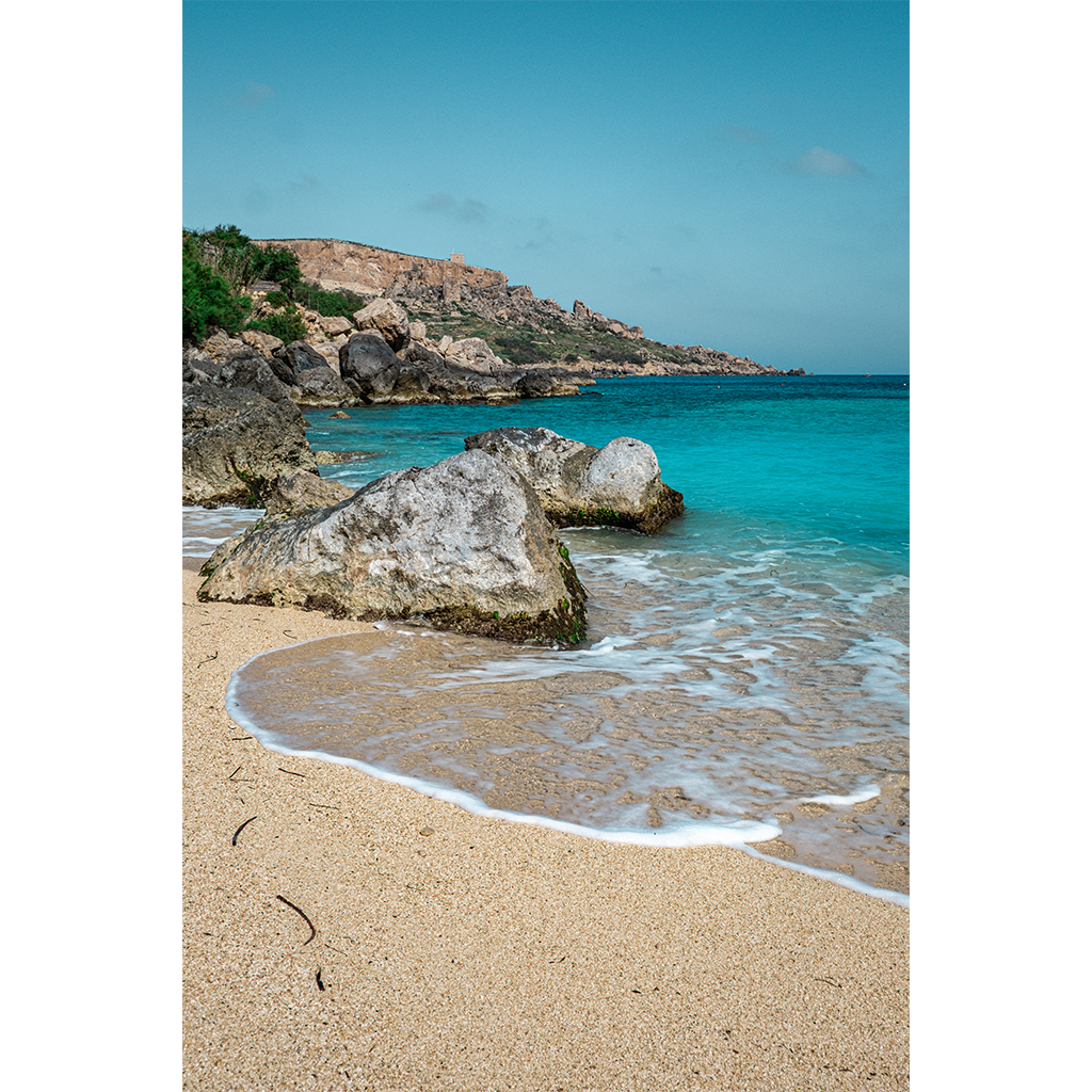 Rocky shoreline with turquoise water and sandy beach