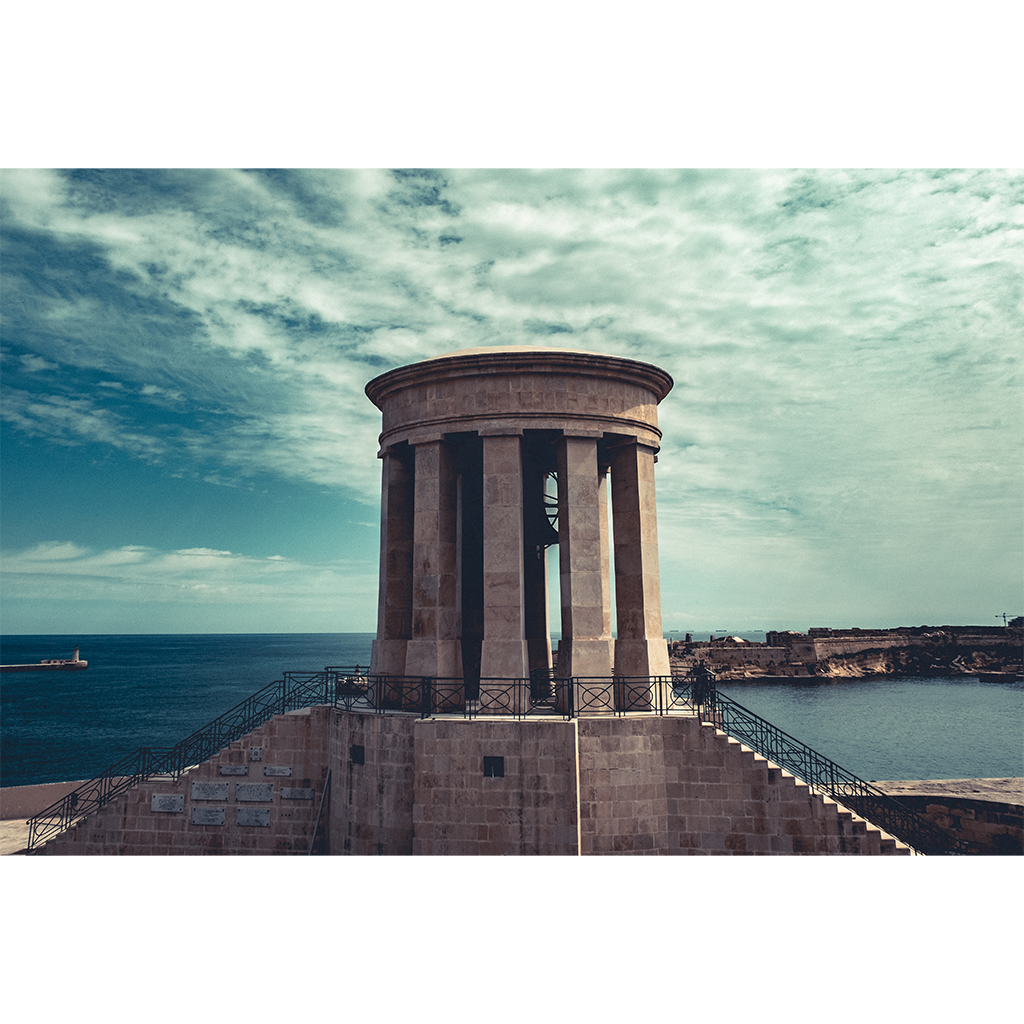Stone coastal monument overlooking blue sea