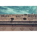 Historic stone fortress wall under cloudy sky