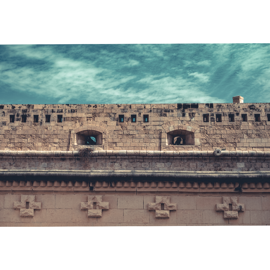 Historic stone fortress wall under cloudy sky