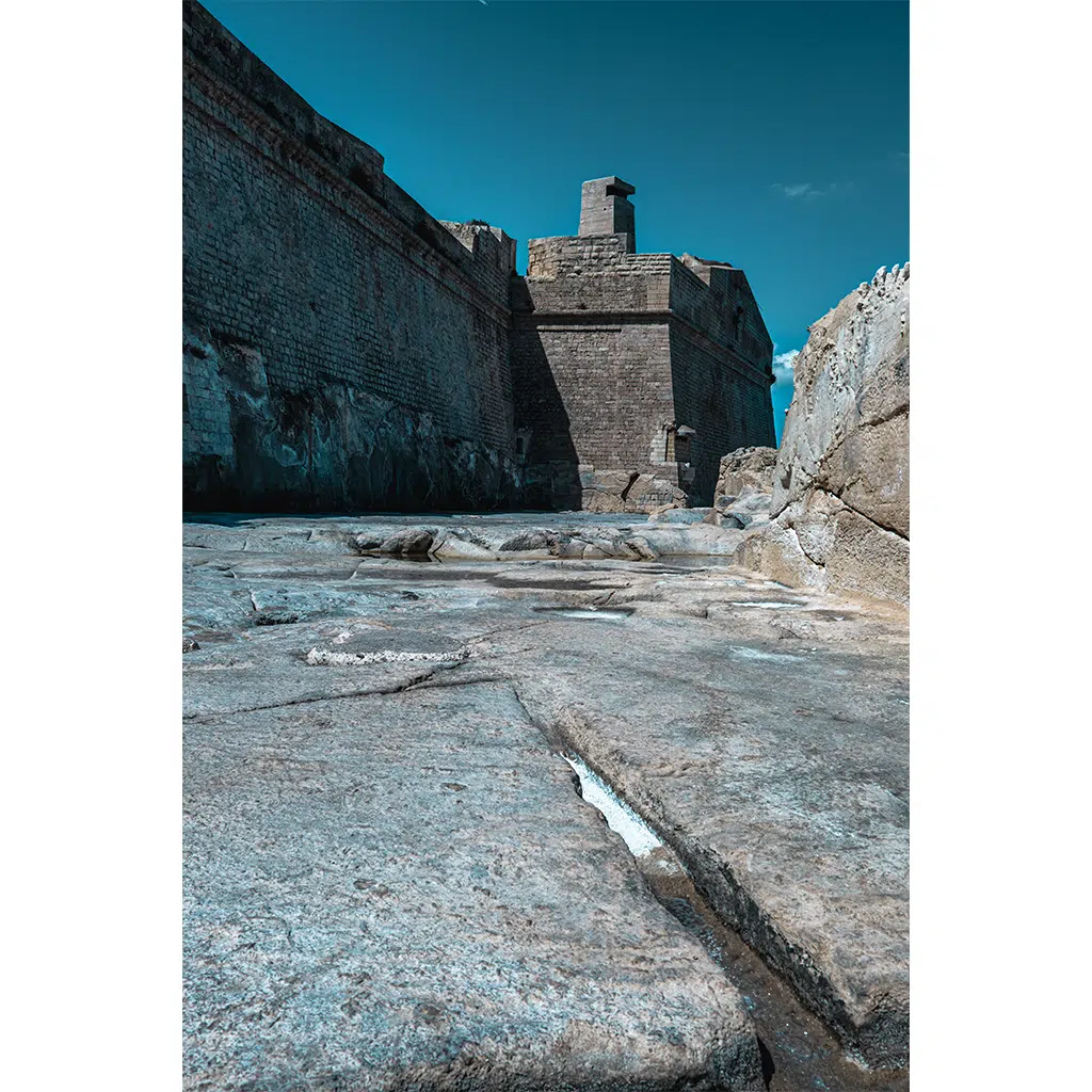 Ancient stone fortress walls under clear blue sky