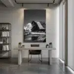 Modern minimalist office with black-and-white bridge artwork