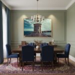 Elegant dining room with blue chairs and chandelier