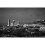 Black and white coastal church and lighthouse landscape