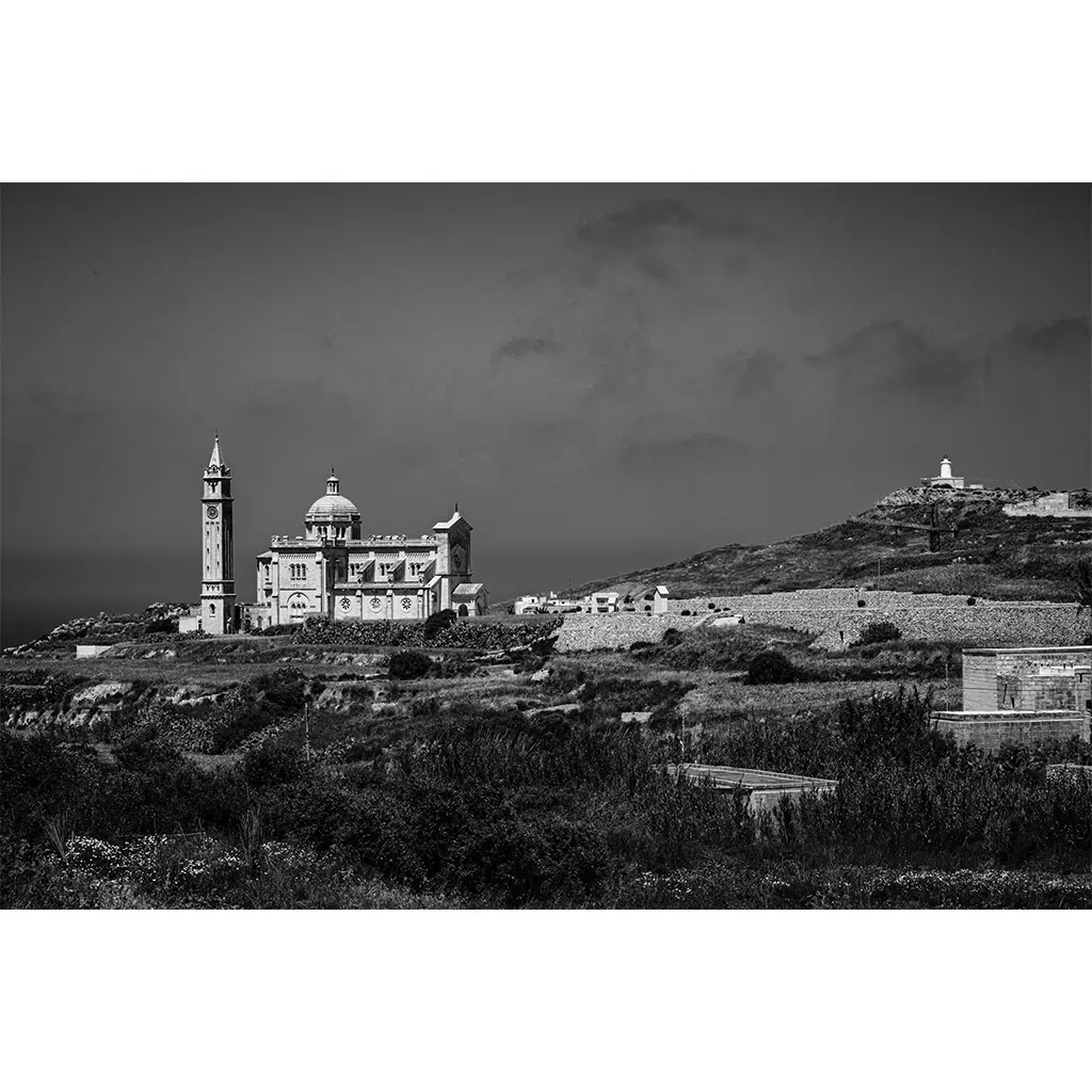 Black and white coastal church and lighthouse landscape