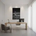 Minimalist office with wooden desk and windmill artwork
